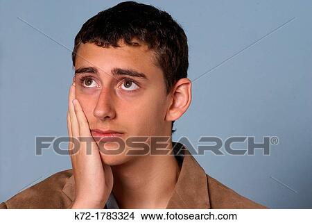 Worried look on face of young teenage man View Large Photo Image Picture - Worried look on face of young teenage man. Fotosearch