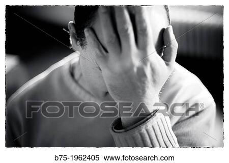 Worried man covering his face with his hand View Large Photo Image Stock Photography - Worried man covering his face with his hand. Fotosearch