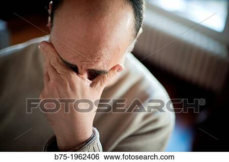 Worried man with hand on face View Large Photo Image Stock Photograph - Worried man with hand on face. Fotosearch