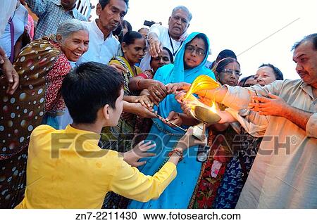 Worshipers are touching the sacred fire from the Aarti, Rishikesh. View Large Photo Image Stock Image - Worshipers are touching the sacred fire from the Aarti, Rishikesh.. Fotosearch