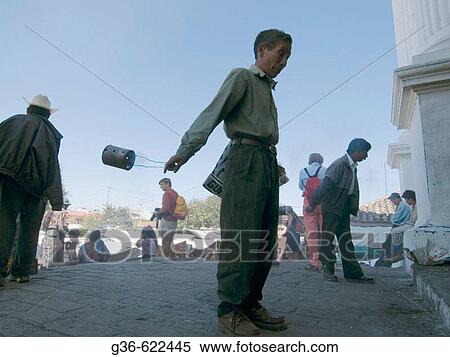 Stock Photography - Worshippers with incense at a church's entrance in Chichicastenango, Guatemala. Fotosearch