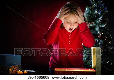 Stock Photo - Wow - it's what I have wished for Young girl can? t believe she actually got this Christmas present. Fotosearch