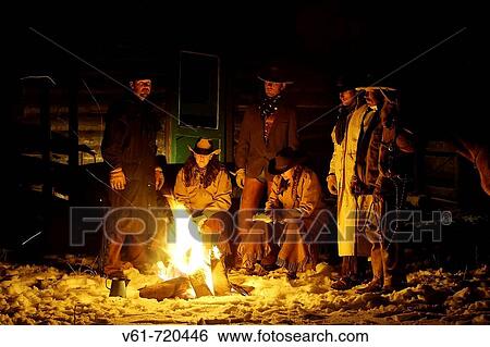 Wranglers gathered by the evening fire in the snow, Shell, Wyoming. Usa View Large Photo Image Stock Photograph - Wranglers gathered by the evening fire in the snow, Shell, Wyoming. Usa. Fotosearch