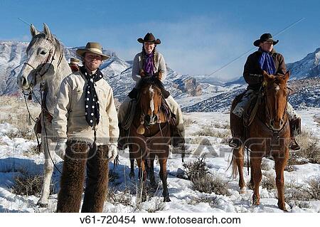 Picture - Wranglers out for a ride in winter, Shell, Wyoming. Usa. Fotosearch