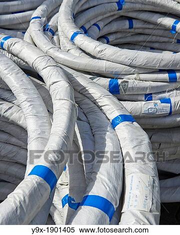 Stock Photography - Wrapped tubes of metal and plastic lines and strips. Fotosearch