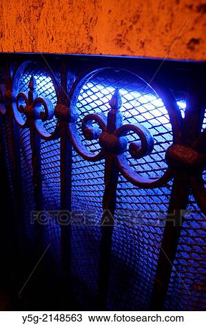 wrought iron fence with spikes and blue light in basement in rome italy View Large Photo Image Stock Image - wrought iron fence with spikes and blue light in basement in rome italy. Fotosearch