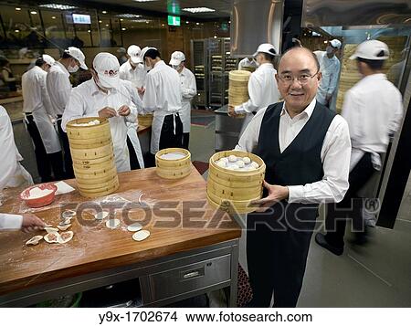 Yang Chi-hua, current owner of the family run renowned dumpling franchise, Din Tai Fung, in the kitchen of one of their flagship restaurants in Taipei, Taiwan View Large Photo Image Picture - Yang Chi-hua, current owner of the family run renowned dumpling franchise, Din Tai Fung, in the kitchen of one of their flagship restaurants in Taipei, Taiwan. Fotosearch