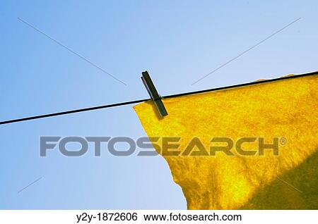 Stock Photograph - Yellow cloth under the sun. Fotosearch