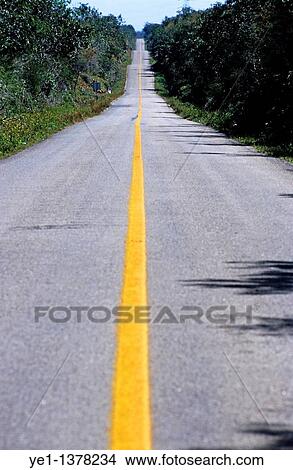 Yellow dividing line marking an empty road between Uxmal and Kabah, Yucatan, Mexico View Large Photo Image Picture - Yellow dividing line marking an empty road between Uxmal and Kabah, Yucatan, Mexico. Fotosearch