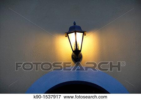 Yellow wall of a residential building with a burning lamp, Gabiano, Pimont, Italy, Europe View Large Photo Image Stock Photo - Yellow wall of a residential building with a burning lamp, Gabiano, Pimont, Italy, Europe. Fotosearch