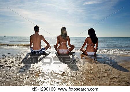 Stock Image - Yoga at sunrise. Fotosearch