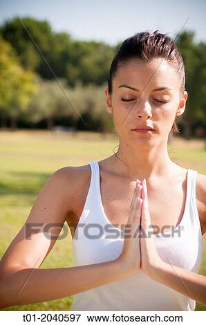 Stock Photo - yoga girl in a park.. Fotosearch