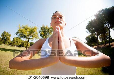 Stock Photo - yoga girl in a park.. Fotosearch