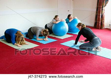 Yoga teacher demonstrating a forward stretch, in a pre-natal yoga class View Large Photo Image Stock Image - Yoga teacher demonstrating a forward stretch, in a pre-natal yoga class. Fotosearch
