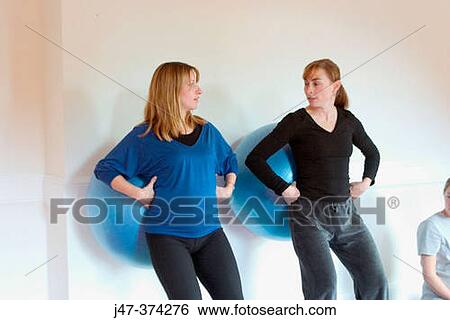 Yoga teacher demonstrating how to use a birthing ball, in a pre-natal yoga class View Large Photo Image Stock Photograph - Yoga teacher demonstrating how to use a birthing ball, in a pre-natal yoga class. Fotosearch