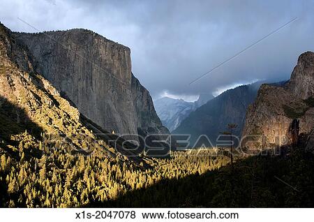 Yosemite Valley famous tunnel view and setting sun. View Large Photo Image Stock Photo - Yosemite Valley famous tunnel view and setting sun.. Fotosearch