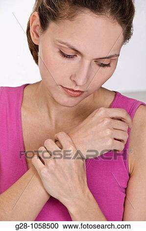 youg woman holding her wrist, sufferring from twisted wrist or rheumatism View Large Photo Image Stock Image - youg woman holding her wrist, sufferring from twisted wrist or rheumatism. Fotosearch