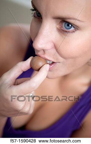 Youn woman eating chocolate View Large Photo Image Stock Photo - Youn woman eating chocolate. Fotosearch