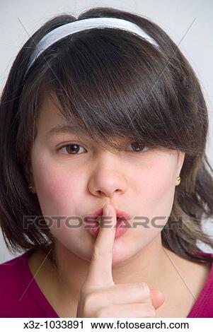 Young 11 year old girl with finger to lips View Large Photo Image Stock Image - Young 11 year old girl with finger to lips. Fotosearch