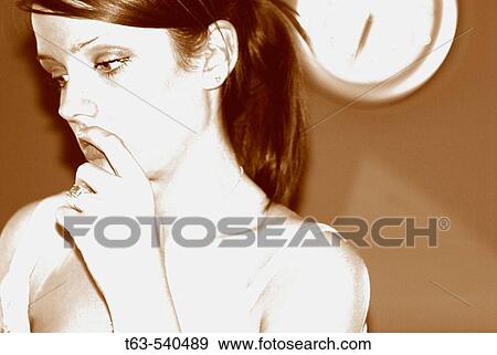 young 20 yr old woman sitting and thinking with clock on wall behind View Large Photo Image Stock Photo - young 20 yr old woman sitting and thinking with clock on wall behind. Fotosearch