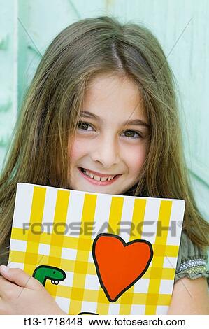 Young 8-year old schoolgirl with a paper notebook View Large Photo Image Stock Photo - Young 8-year old schoolgirl with a paper notebook. Fotosearch