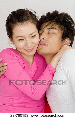 Young adult couple embracing View Large Photo Image Stock Image - Young adult couple embracing. Fotosearch
