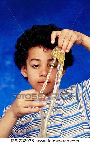 Young African American boy playing with elastic toy View Large Photo Image Stock Photograph - Young African American boy playing with elastic toy. Fotosearch