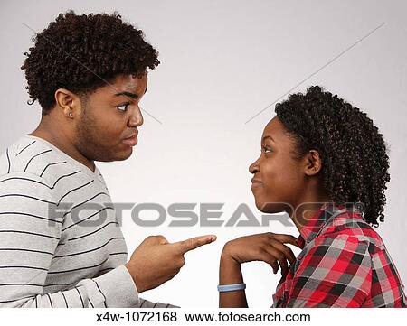 Young African-American couple facing off? Katharine Andriotis View Large Photo Image Stock Photo - Young African-American couple facing off? Katharine Andriotis. Fotosearch