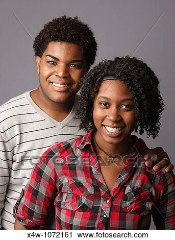 Stock Image - Young African-American couple posing for portrait? Katharine Andriotis. Fotosearch