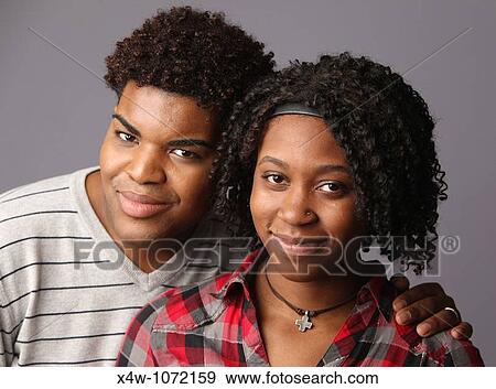 Young African-American couple posing for portrait? Katharine Andriotis View Large Photo Image Stock Photo - Young African-American couple posing for portrait? Katharine Andriotis. Fotosearch