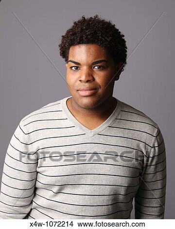 Young African-American man posing for portrait View Large Photo Image Picture - Young African-American man posing for portrait. Fotosearch