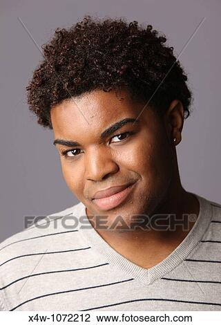 Stock Image - Young African-American man posing for portrait. Fotosearch