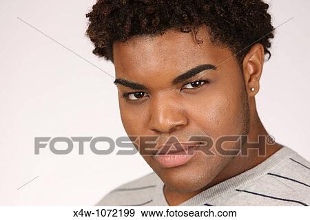 Young African-American man posing for portrait View Large Photo Image Stock Photo - Young African-American man posing for portrait. Fotosearch