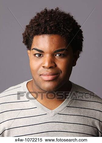 Stock Photography - Young African-American man posing for portrait. Fotosearch