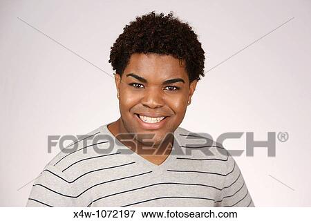 Stock Photo - Young African-American man smiling and posing for portrait. Fotosearch