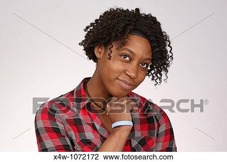 Stock Image - Young African-American woman posing for portrait. Fotosearch