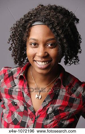 Young African-American woman posing for portrait View Large Photo Image Stock Photograph - Young African-American woman posing for portrait. Fotosearch