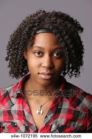 Young African-American woman posing for portrait View Large Photo Image Stock Photography - Young African-American woman posing for portrait. Fotosearch