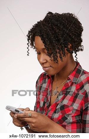 Young African-American woman texting View Large Photo Image Stock Image - Young African-American woman texting. Fotosearch