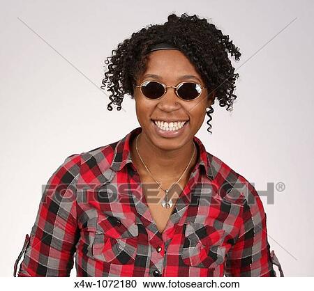 Young African-American woman with sunglasses posing for portrait View Large Photo Image Stock Image - Young African-American woman with sunglasses posing for portrait. Fotosearch