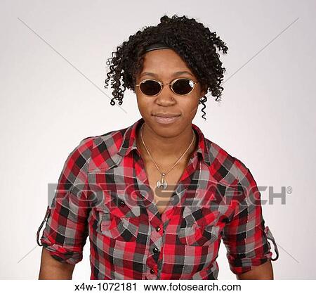 Young African-American woman with sunglasses posing for portrait View Large Photo Image Stock Image - Young African-American woman with sunglasses posing for portrait. Fotosearch