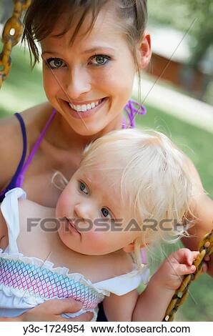 Young and happy mother with her blond baby girl View Large Photo Image Picture - Young and happy mother with her blond baby girl. Fotosearch