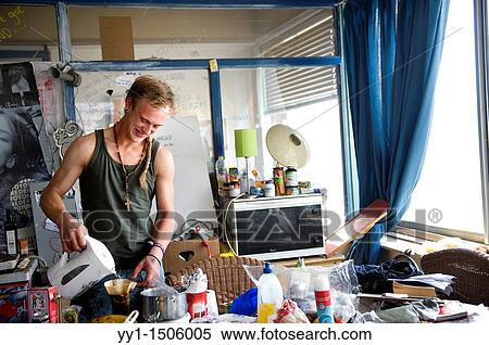 Young art-student, living in a squad, making a cup of coffee. View Large Photo Image Stock Photography - Young art-student, living in a squad, making a cup of coffee.. Fotosearch