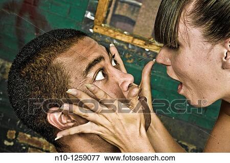 Stock Photo - Young Asian and Caucasian couple in an old factory. Fotosearch