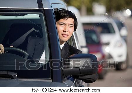 Young Asian businessman in a traffic jam View Large Photo Image Picture - Young Asian businessman in a traffic jam. Fotosearch