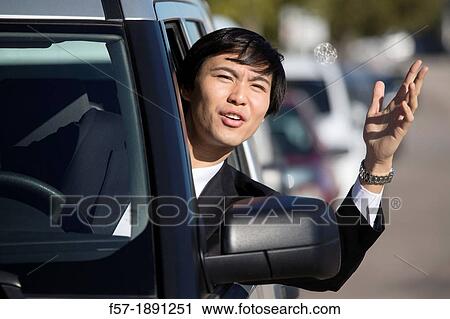 Young Asian businessman in a traffic jam View Large Photo Image Stock Image - Young Asian businessman in a traffic jam. Fotosearch