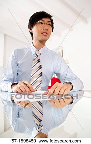 Young Asian businessman signing contracts View Large Photo Image Stock Image - Young Asian businessman signing contracts. Fotosearch