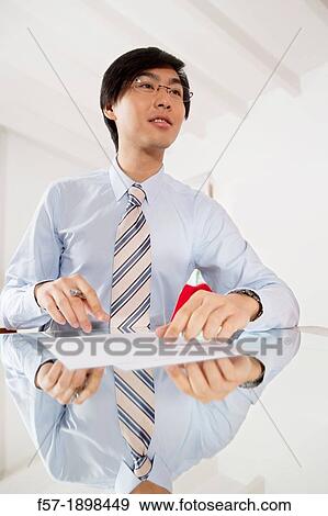 Young Asian businessman signing contracts View Large Photo Image Stock Photo - Young Asian businessman signing contracts. Fotosearch