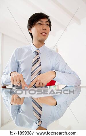 Young Asian businessman signing contracts View Large Photo Image Stock Photo - Young Asian businessman signing contracts. Fotosearch