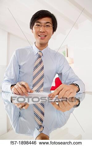 Young Asian businessman signing contracts View Large Photo Image Stock Photograph - Young Asian businessman signing contracts. Fotosearch